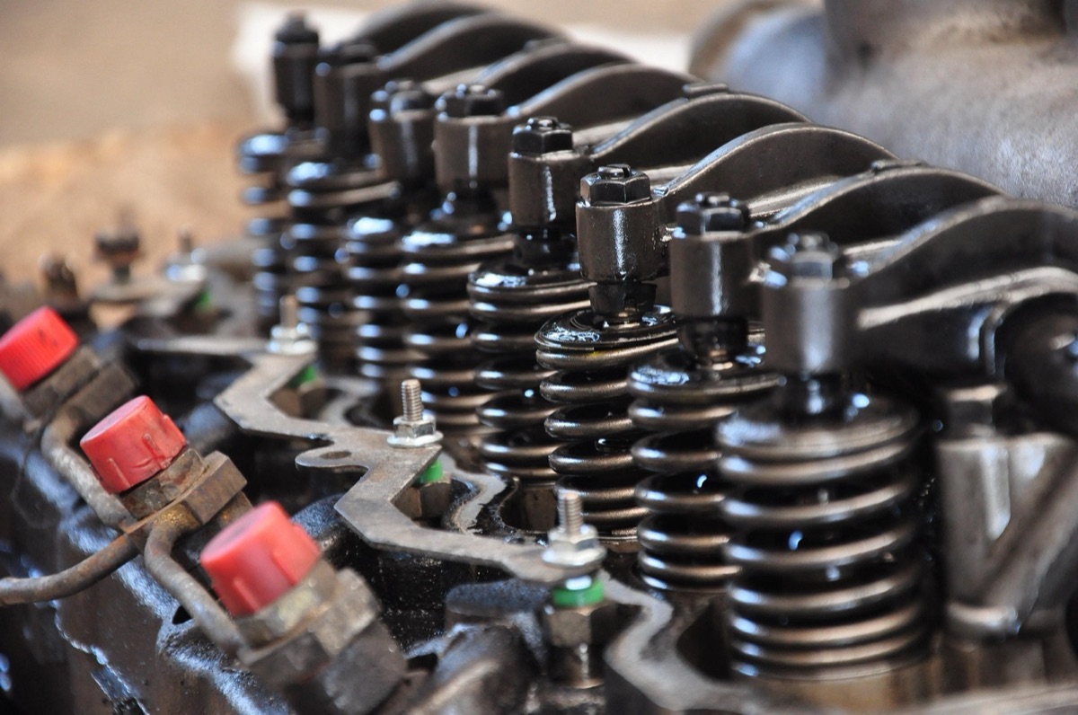 Close-up of an engine cylinder head with valve springs and rocker arms